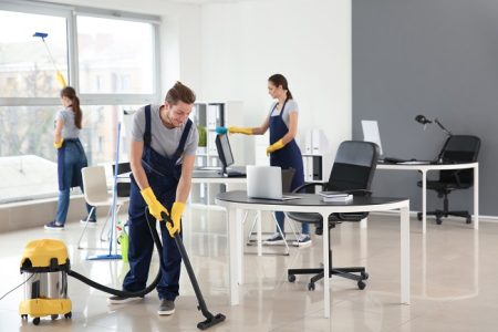 team of janitors cleaning office