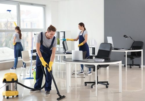 team of janitors cleaning office